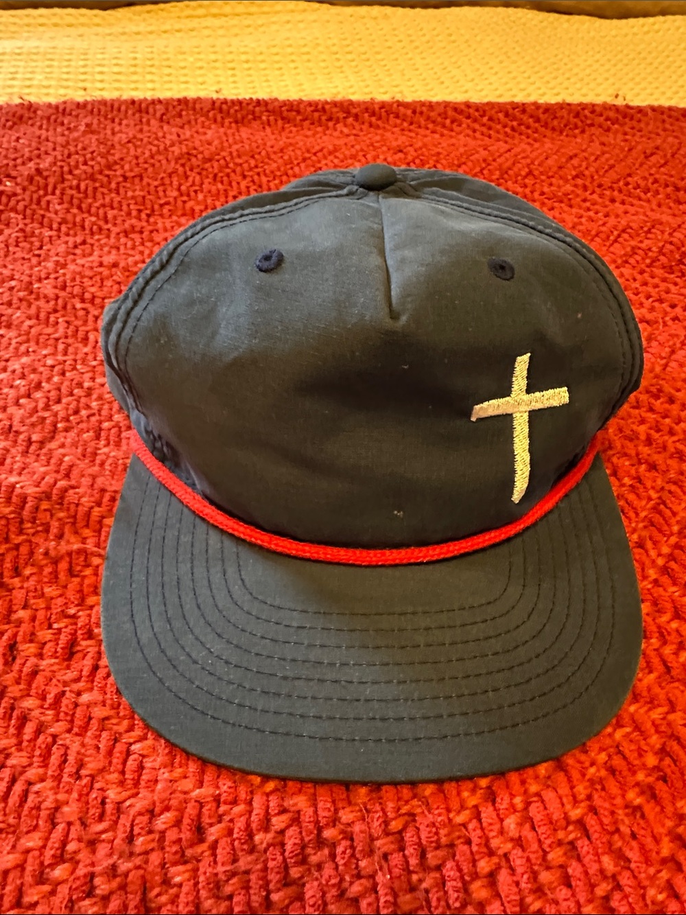 Blue Baseball Cap with Red Trim and white Cross